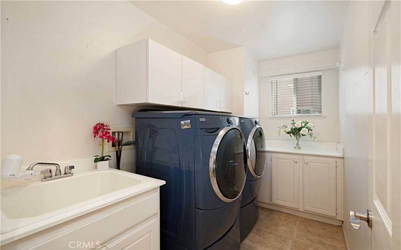 Downstairs laundry room with sink.