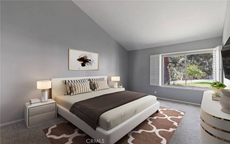 Primary bedroom with vaulted ceilings. Virtually staged.