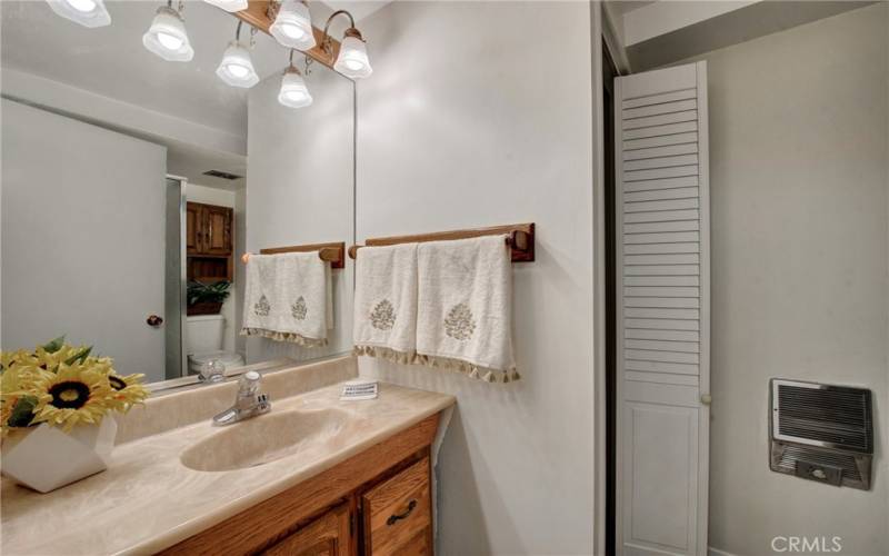 Guest or second Bath Newer Vanity, Newer light fixtures and Stacked Washer and dryer in bath Closet