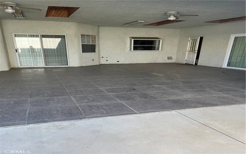 Back yard covered patio with skylights