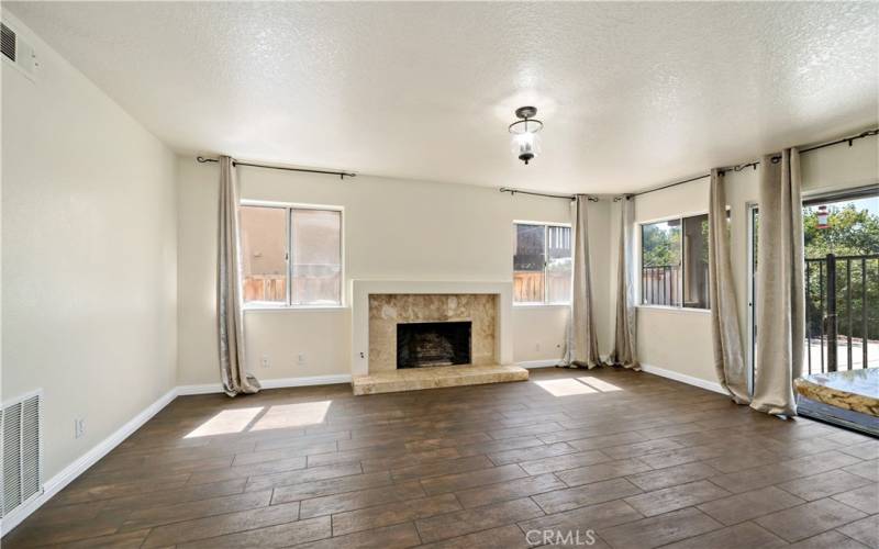 Family room w fireplace and sliding doors to rear patio and pool area