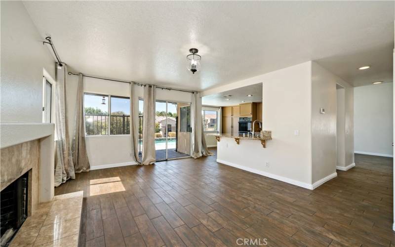 Family room looking thru to kitchen and sliding door to rear yard/pool