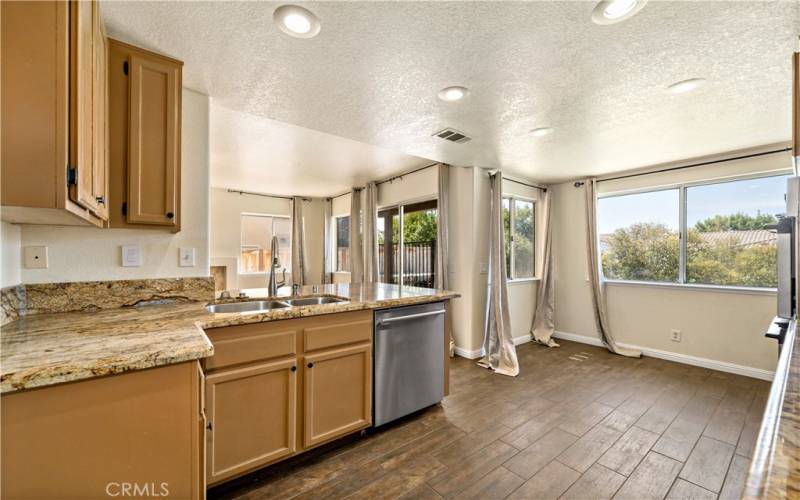 Kitchen w granite countertops, breakfast nook and stainless steel dishwasher