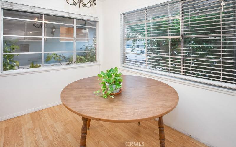 The freshly painted dining room fittingly adjoins the kitchen and with its large sparkling windows, drop down lighting and gleaming wood laminate floors, it is perfect for any occasion.