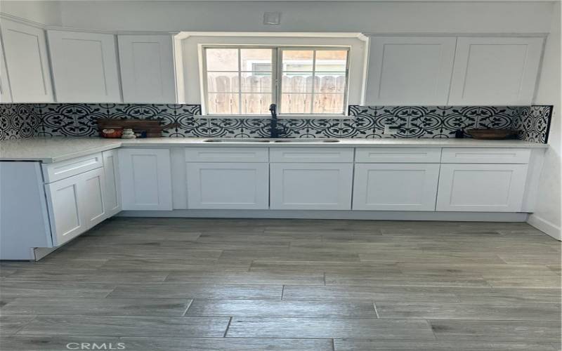 new quartz counter,cabinets and tile backsplash