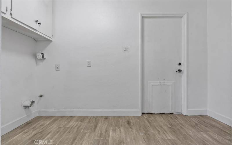 indoor laundry next to half bath and garage