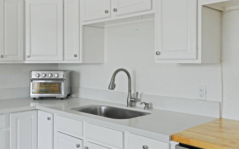 Basin Sink and butcher block meal prep area.