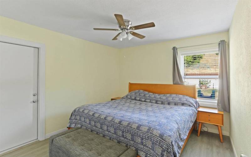 bedroom with access door to backyard patio area.