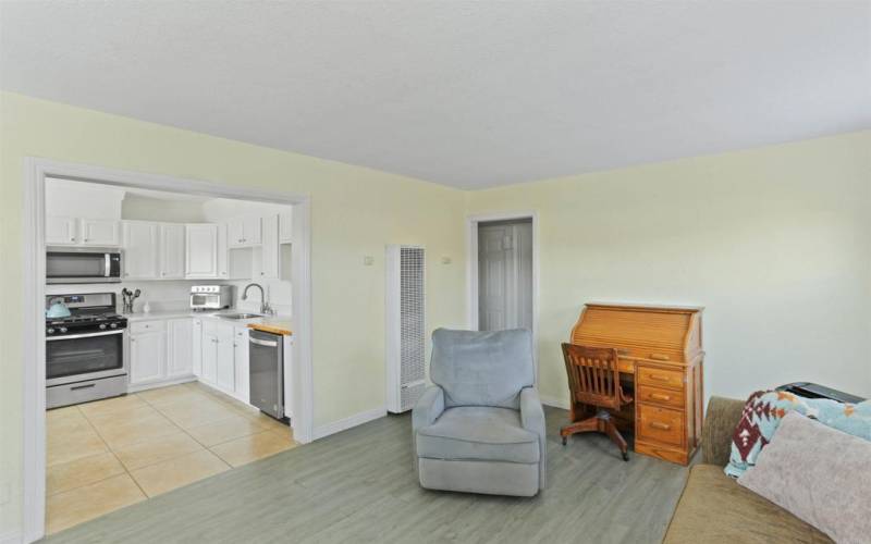 Living room showing kitchen area and hall entry.