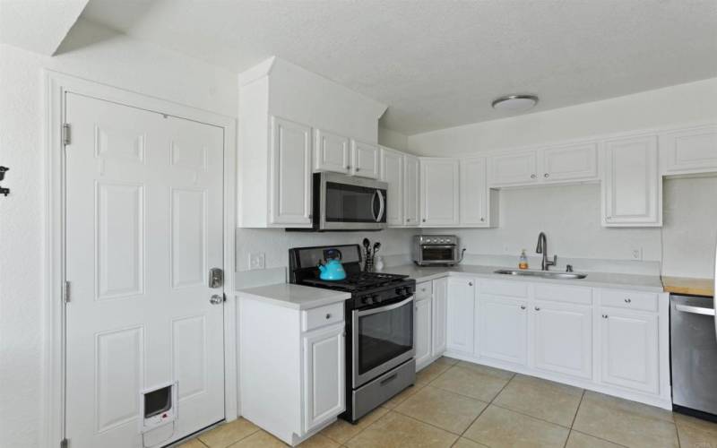 Kitchen showing garage access door.