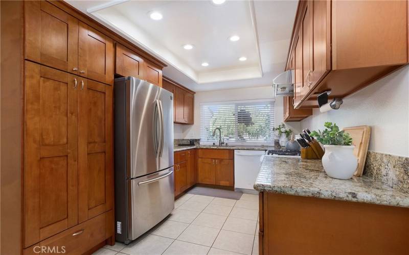 Kitchen has beautiful cabinetry and granite counters