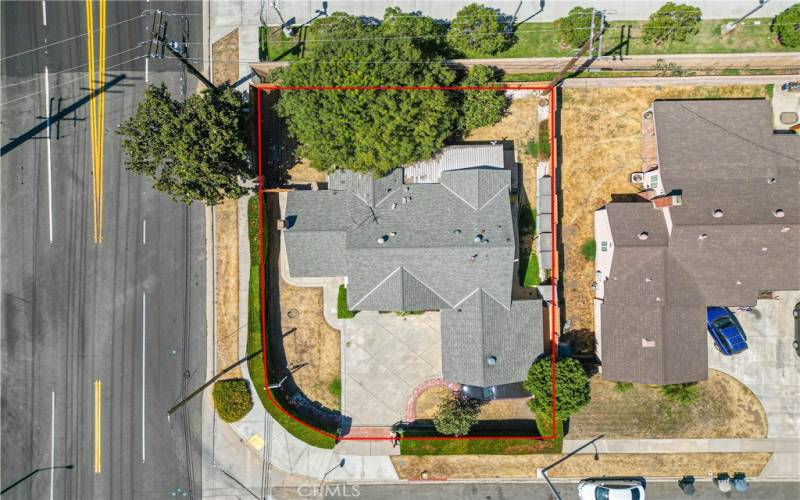 Aerial view of home with hedges providing privacy and gated access to parking. Street to the left is Covina Blvd.