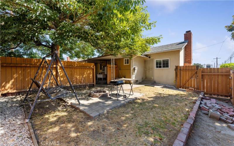 Fence is separating the backyard. Door on the right opens to the family room with fireplace.