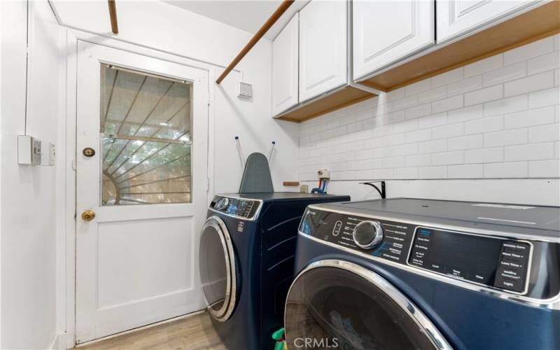 Indoor laundry at the end from the kitchen with exterior door to the back patio.