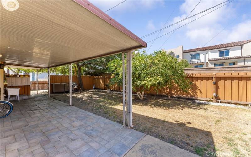 Spacious backyard with covered patio.