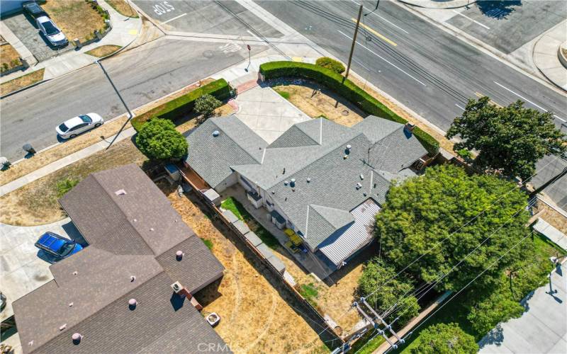 Aerial view of home with hedges providing privacy and gated access to parking. Street to the right is Covina Blvd.