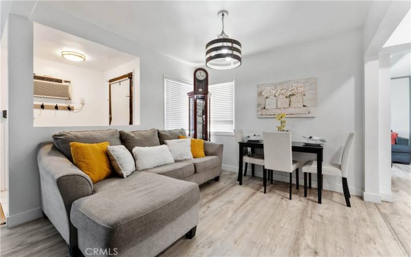 This is a dining area with updated light fixture. Lovely updated flooring throughout.