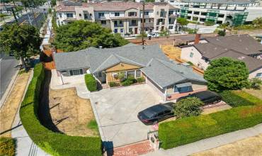 Aerial view of home with hedges providing privacy and gated access to parking.