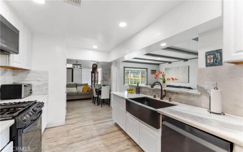 Updated kitchen with marble counters/backsplash, recessed lighting.