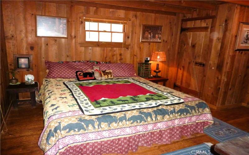 The Bedroom On The Main Level Of The Cabin Is Right Next To The Living Area Of The Cabin