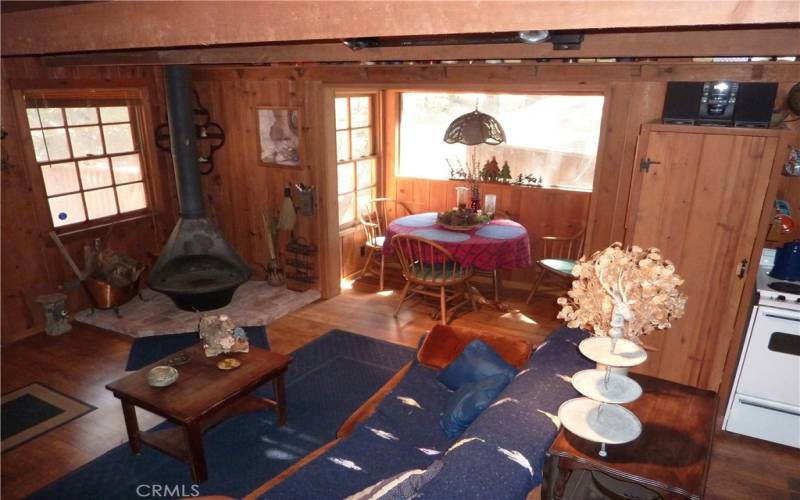 View From Above Of The Living Area Featuring The Woodburning Stove And Dining Nook