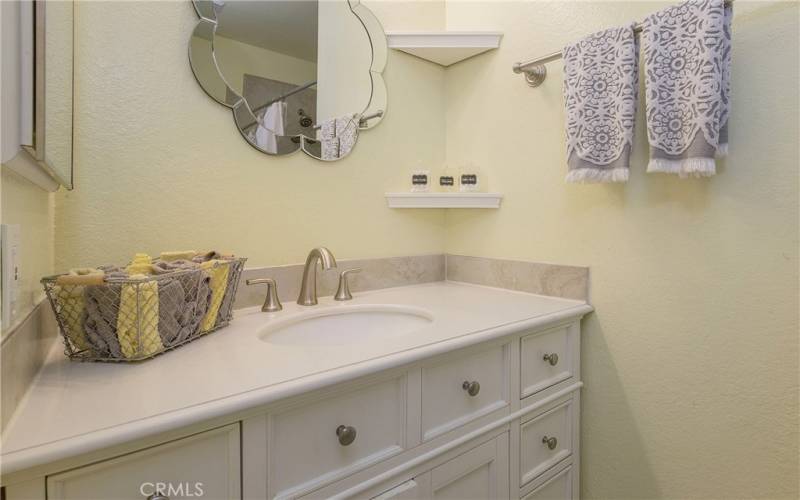 Recently remodeled secondary bath with tile shower and quartz countertops.