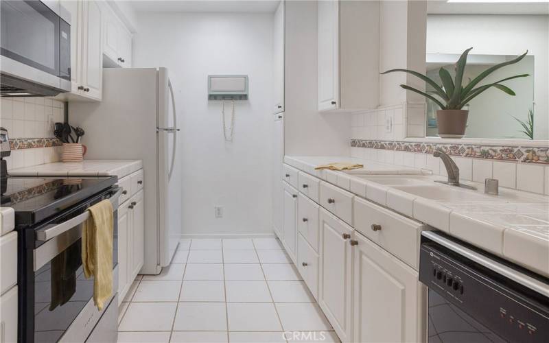 Kitchen that opens to great room and dining room with skylight