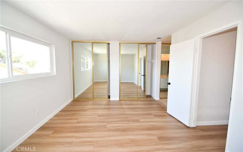 Primary Suite with Mirrored Wardrobes.