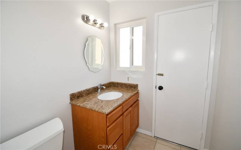 Remodeled downstairs half bath.  Door goes to side yard