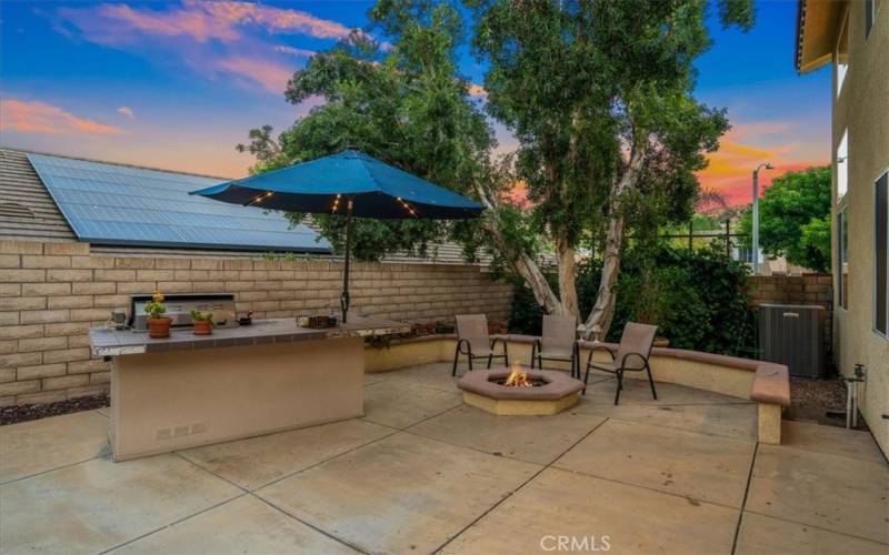 Outdoor BBQ with bar counter and cozy fire pit