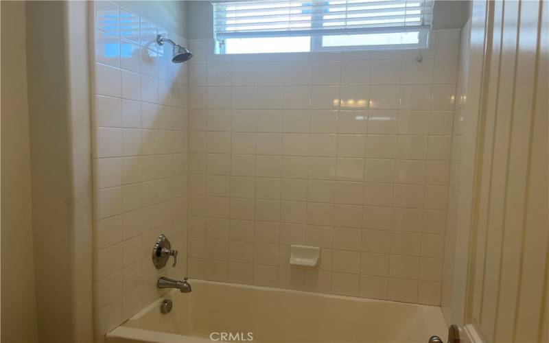 Tub and shower off one of the bedrooms