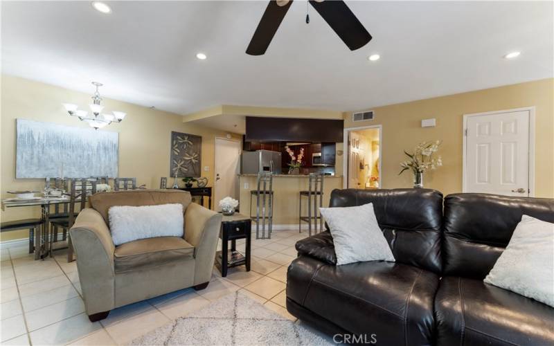 Family/Dining/Updated Kitchen. Doorway near updated kitchen leads to spacious garage. Doorway open near kitchen is the lower level powder room. Door on the right is the closet.