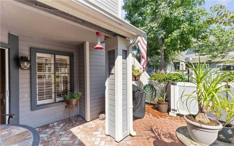 Spacious patio with brick herringbone pattern.