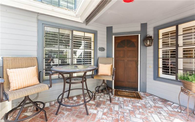 Spacious patio with brick herringbone pattern.