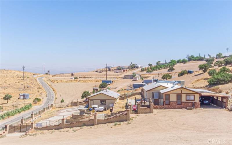 View of residence, detached garage, horse facilities and plenty of open space waiting for new ideas!