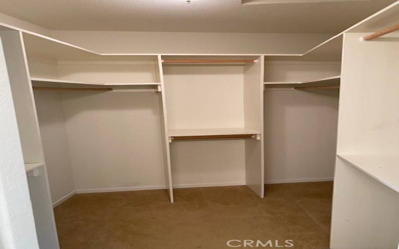 Large walk in closet in primary bedroom dressing area