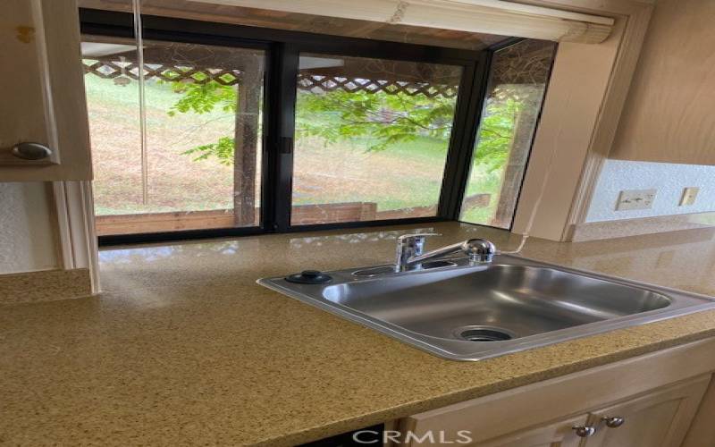 Garden window over sink overlooking rear deck