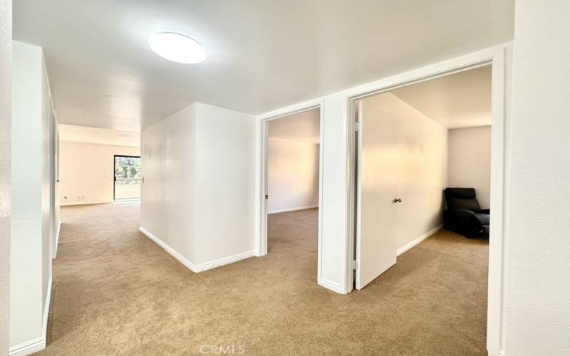 Entry looking down hall past 2 guest bedrooms, Guest bath on the left and towards great room