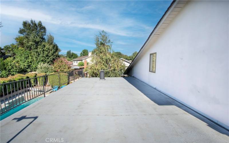 Large balcony off of master suite overlooking the pool and backyard