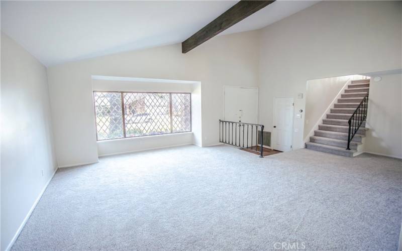 Large living room featuring beveled front window