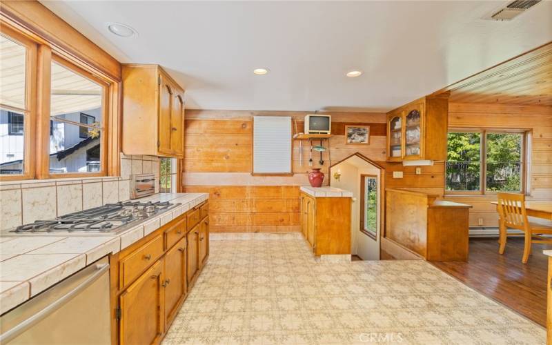 kitchen area showing stairs that lead to lower level