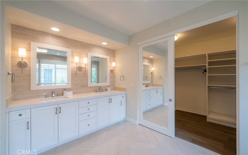 Bathroom area with double sinks and walk-in closet