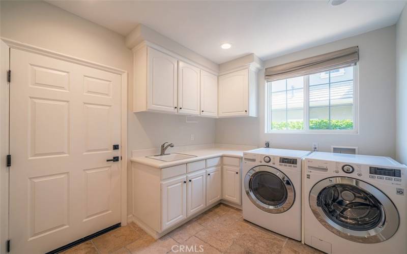 Main Floor Laundry Room and entrance to 3-car garage