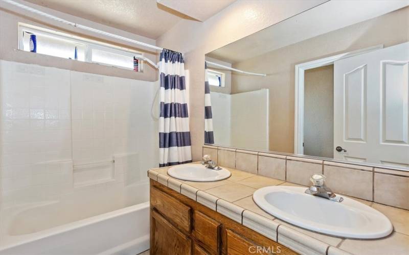 The guest bath also has dual sinks.