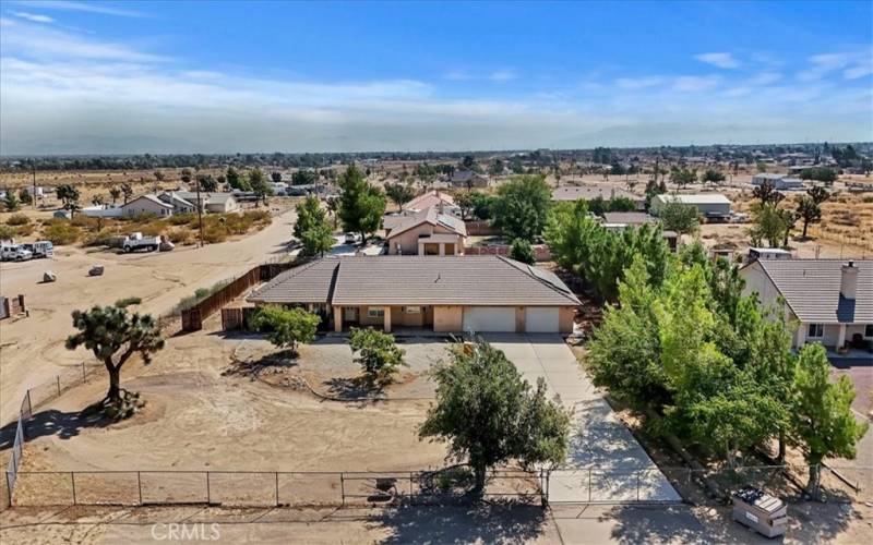 Arial view showing front of the home and the long wide driveway.