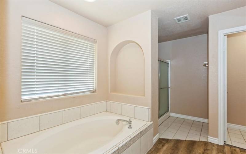 Set up your own relaxation space with this over-sized tub and alcove space just waiting for your favorite view. And a separate shower stall just beyond.