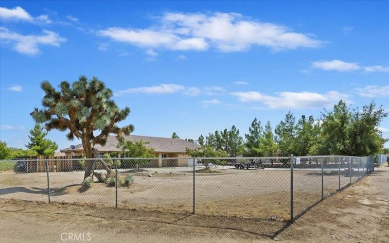 This angle is the front corner of the property. The road along the left of the property provides gated access to the back portion of the lot.