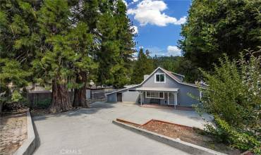 Tucked beyond a fully gated driveway, welcome to 320 Skyview Lane in Cedarpines Park