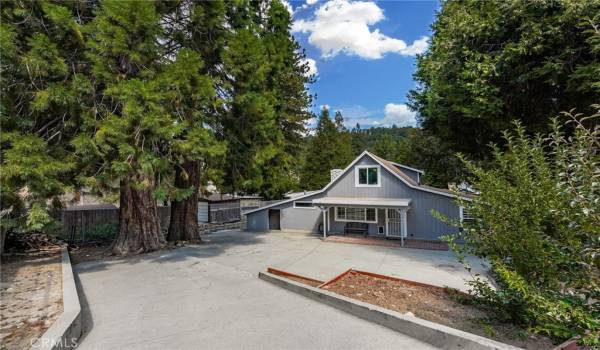 Tucked beyond a fully gated driveway, welcome to 320 Skyview Lane in Cedarpines Park