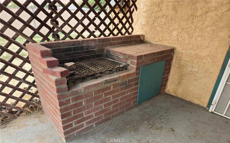 Built-in BBQ back house, front porch.